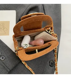 Internal view of velvet chain bag showing storage capacity for cosmetics and accessories