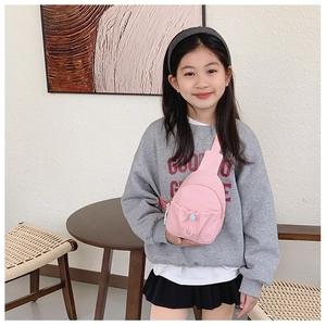 Close-up of pink nylon kids chest bag with adjustable strap and drawstring pocket