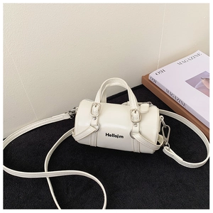 Detailed close-up of white mini cylinder bag with Hellojm print and silver hardware