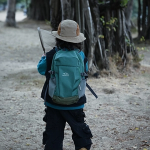Forest green kids outdoor hiking backpack with mountain logo and mesh side pockets