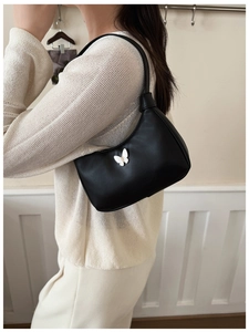 Détail du sac demi-lune noir avec papillon blanc 3D porté par un enfant mannequin