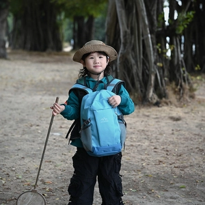 Kids outdoor sports backpack in light blue with Mountains logo and side mesh pockets