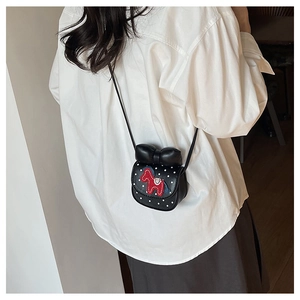 Détail d'un petit sac bandoulière noir pour filles avec un motif poney rouge brodé