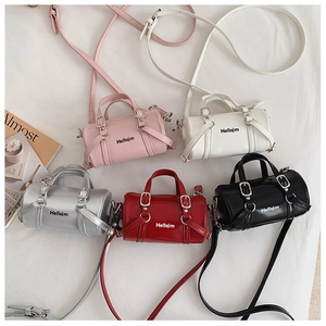 Top view of mini cylinder crossbody bags in pink, white, silver, red, and black colors