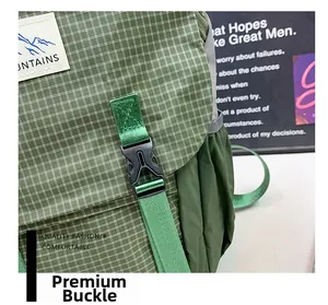 Close-up of durable black buckle and green checkered fabric on children hiking backpack