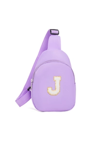 Macro detail of purple nylon chest bag showing the J letter patch and gold sequins