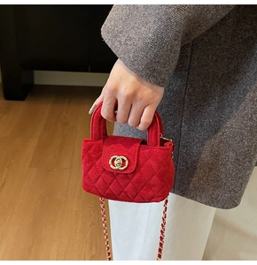 Detail of red quilted velvet mini bag for girls with gold chain strap and turn-lock