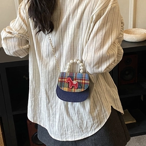 Cute kids checkered crossbody bag with pony embroidery and pearl handle shown on model