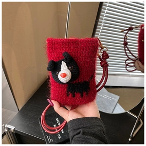 Detail of red handmade crochet mini crossbody bag featuring a cute puppy cartoon design