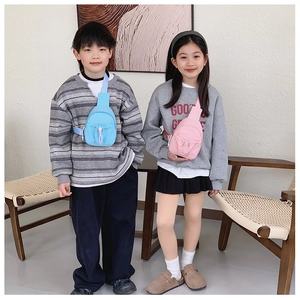 Close-up of lightweight nylon kids chest bags in blue and pink with adjustable straps