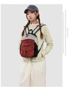 Detail of multi-color nylon hiking backpack with cross elastic cords on beige outfit