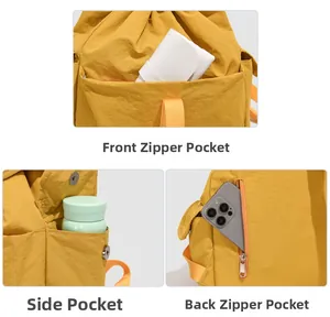 Detailed view of yellow backpack compartments showing front pocket, side pocket, and anti-theft back pocket