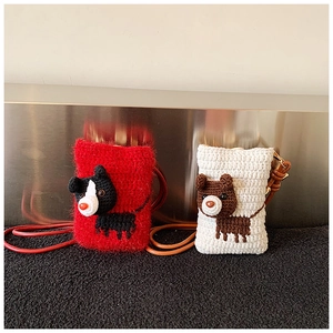 Detail of handmade crochet shoulder bags with cute puppy and bear animal designs