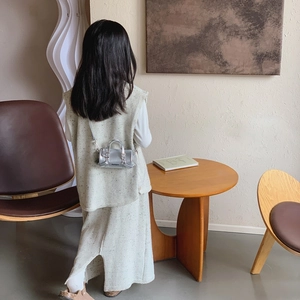 Kids minimalist beige knit vest and skirt set with a silver mini crossbody bag outfit