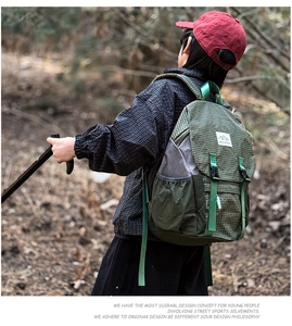 Close-up of green checkered hiking backpack featuring durable buckle straps and logo