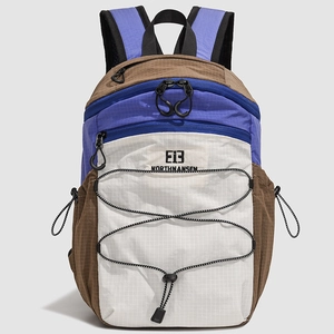 Detail view of durable tricolor nylon hiking backpack with elastic cord and logo
