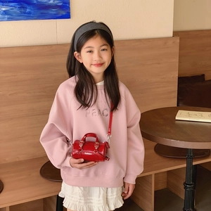 Mini red leather cylindrical Boston bag for kids with adjustable shoulder strap and handles