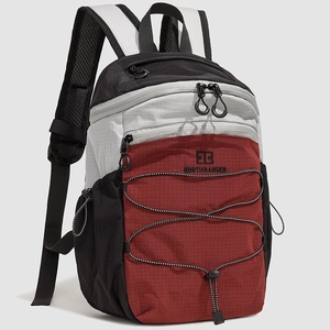 Detail of hiking backpack showing tear-resistant nylon fabric and elastic drawstring system