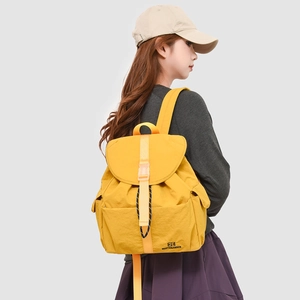 Side view of a bright yellow large capacity school backpack on a child model's back