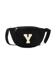 Detail of black nylon kids chest bag featuring a white letter Y patch with gold glitter