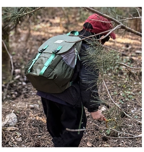 Action shot of kids outdoor hiking backpack with green grid pattern in forest