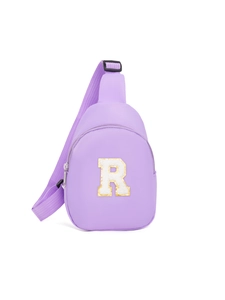 Detailed view of lilac purple sling bag with white fuzzy letter R patch and adjustable strap