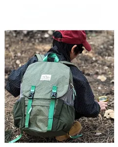 Kids green plaid outdoor backpack with side mesh pocket and buckle strap detail