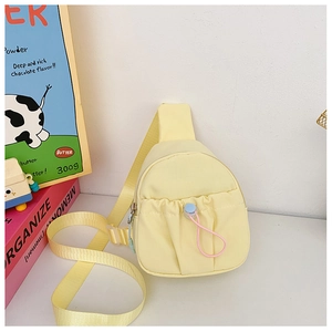 Close-up of lightweight yellow crossbody chest bag for kids with adjustable strap and front pocket