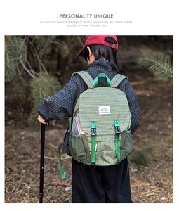 Outdoor scene of a child wearing a green plaid hiking backpack in a forest setting