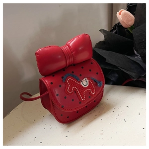 Détail du sac enfant rouge avec nœud 3D, pois noirs et broderie de cheval sur rabat