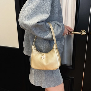 Sac bandoulière enfant doré minimaliste avec un ornement décoratif de papillon rose