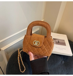 Detailed view of brown velvet quilted mini bag with gold chain strap and top handle