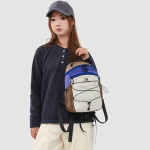 Lightweight outdoor hiking backpack in blue, brown, and off-white nylon patchwork design