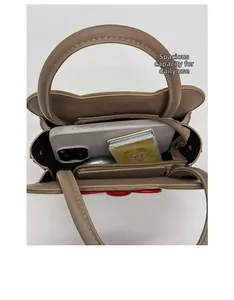 Top view of brown square bag interior showing storage space for phone and wallet