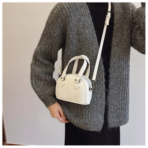 Close-up of a white lychee grain leather mini handbag with adjustable strap for girls
