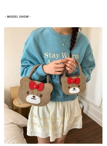 Girl modeling two sizes of cute bear handbags with red bows and chain straps
