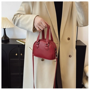 Detailed close-up of a red litchi texture mini shell bag with silver hardware for kids