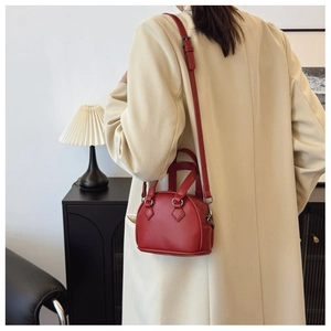 Red lychee pattern mini shell bag shown as a crossbody purse on a child model
