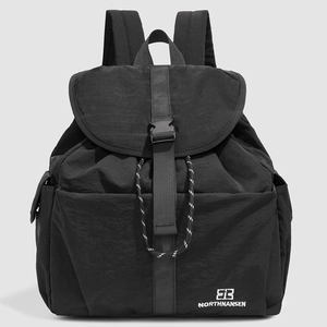 Close-up of durable black nylon school backpack featuring drawstring and buckle closure detail