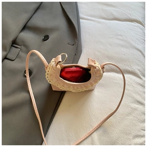 Internal view of mini pink lace bag showing capacity with Kiko lipstick makeup inside