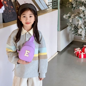 Kids purple chest bag with sequin letter E and adjustable strap shown on model