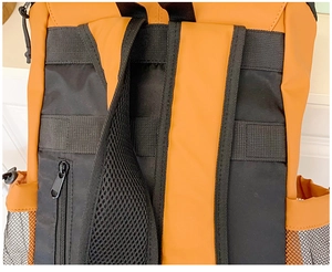 Detailed view of breathable mesh straps and side pockets on a durable nylon backpack