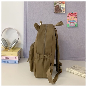 Side view of cute brown bear backpack with 3D ears and elastic side pocket for kids