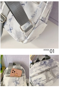 Detail of white corduroy backpack with blue butterfly print and grey fabric straps