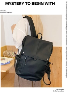 Detail of black multi-pocket backpack with metal snap closures and side mesh pouch