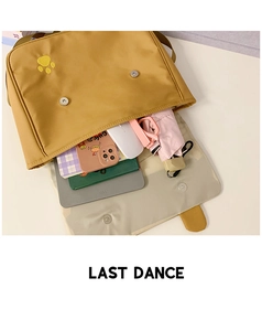 Detailed view of yellow canvas bag interior showing large capacity for tablet and items