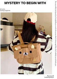 Detail of cute brown bear cartoon backpack showing adjustable straps and zipper closure