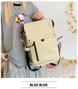 Detail view of cream school backpack with front zipper, flap closure and side mesh pocket