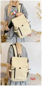 Detail view of cream school backpack with side mesh pockets and buckle lid design
