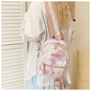 Close-up of butterfly print and calligraphy on children backpack with purple gradient